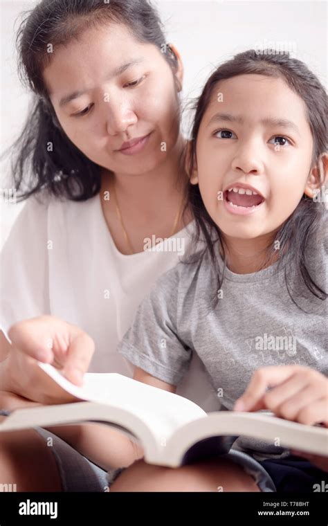 Close Up Mother And Daughter Read Books Together Women Teaching Girl