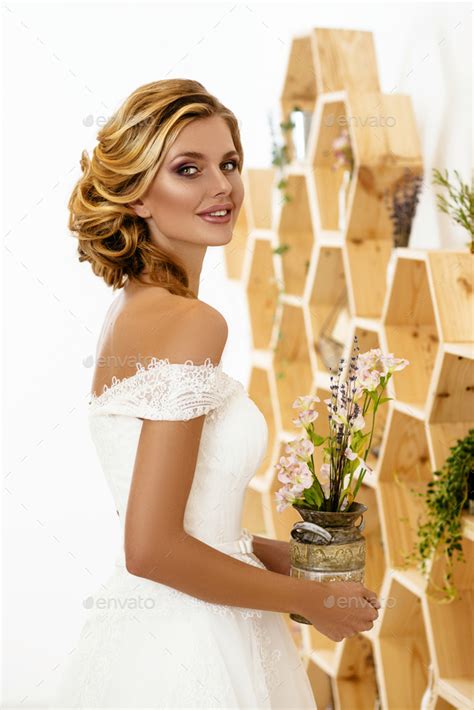 Beautiful Sexy Blonde Bride Posing In Wedding Dress In White Room Stock Photo By Nikita Karchevskyi