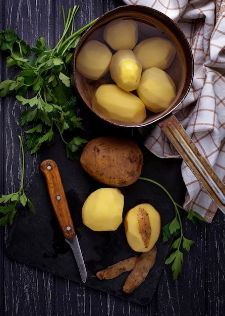 Premium Photo Uncooked Peeled Potatoes On Dark Background