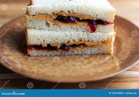 Peanut Butter and Jelly Sandwich on White Bread, Cut in Half and ...