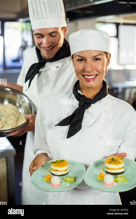 Portrait Of Female Chef Presenting Dessert Plates Stock Photo Alamy