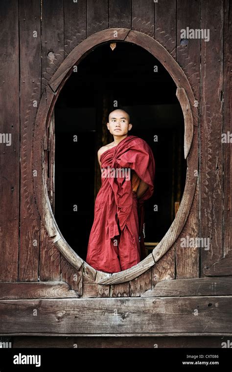 Buddhist Monk Standing At A Window Shwe Yan Bye Monastery In Burma