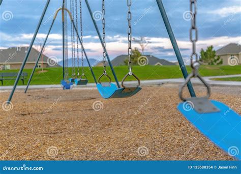 Swing With Homes And Mountain In The Background Stock Photo Image Of