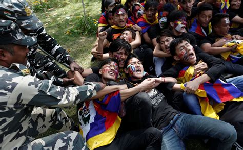 Police Officers Detain Tibetans During A Protest Held To Mark The 60th