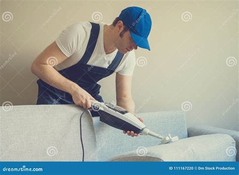 Man In Uniform Cleaning Sofa Stock Photo Image Of Housekeeping