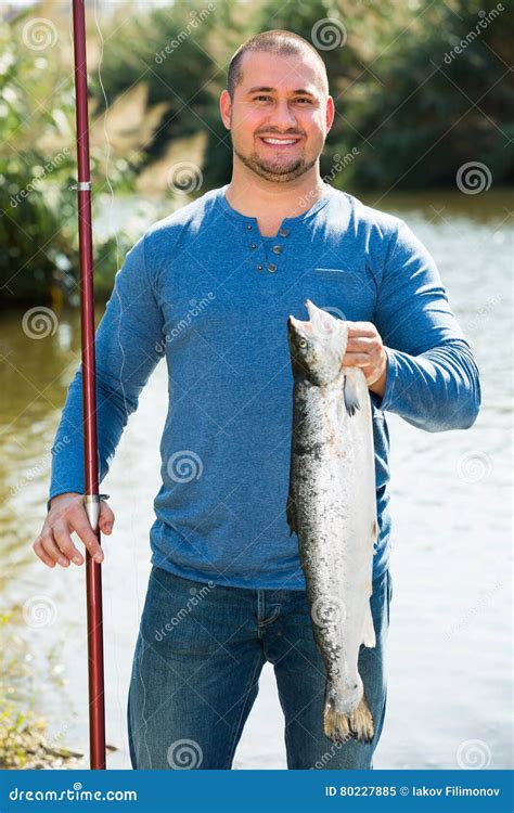 Fisherman Holding Fish Near Wild River Stock Image Image Of Forest