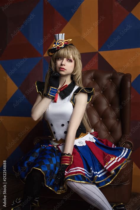 Cosplay of school idol / young cute beautiful girl anime cartoon sits ...