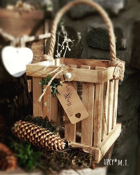 A Wooden Basket With A Tag Hanging From It S Side Next To Pine Cones