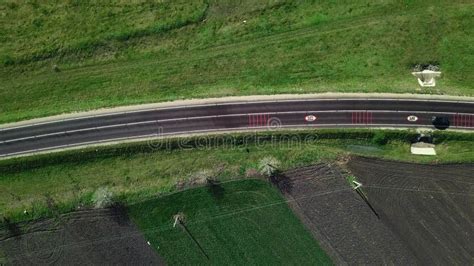 Aerial Top View Of Asphalting National Road Between Green Field And