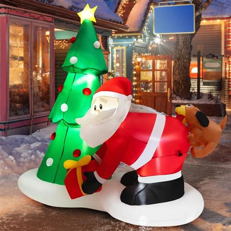 An Inflatable Santa Clause With A Christmas Tree