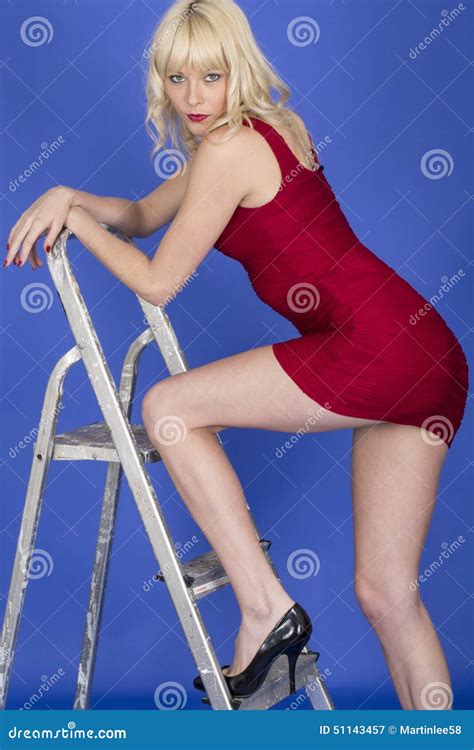 Young Woman Posing Stepping On Ladder Revealing Long Legs And Thighs