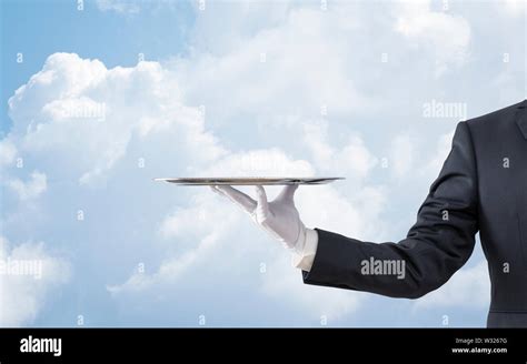 Waiter Holding Empty Silver Tray Over Blue Sky Stock Photo Alamy