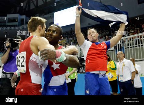 The United States Sam Mikulak Left Hugs Cuba S Manrique Larduet