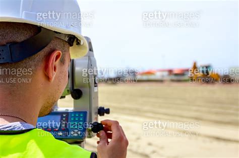 Civil Engineer Geodesist Is Working With Total Station On A Building