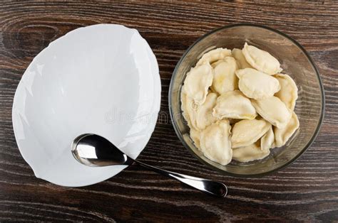 Dish Spoon Dumplings With Butter In Transparent Bowl On Wooden Table