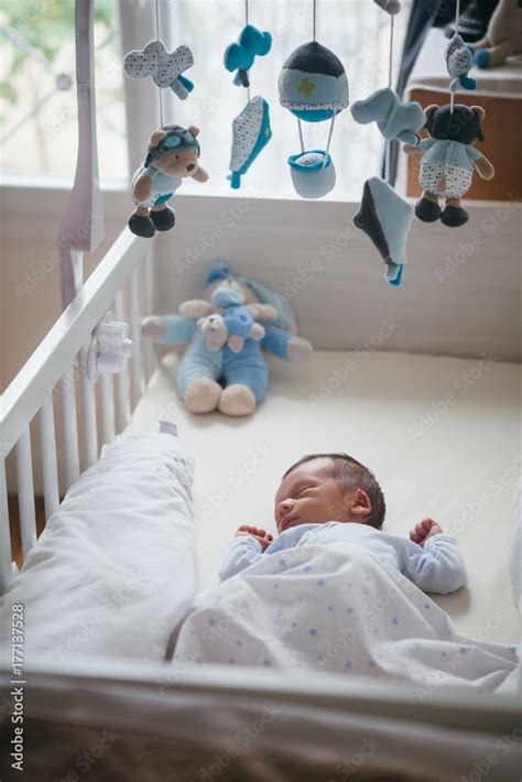 Newborn boy sleeping in a crib Stock Photo | Adobe Stock