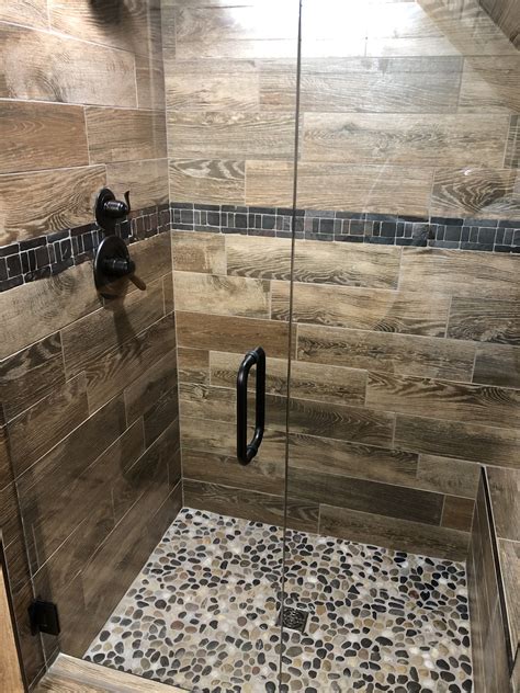 Rustic Wood Look Tile Shower With Pebble Floor