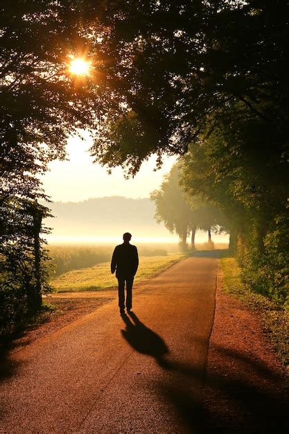 Premium Photo Silhouette Man Walking On Road