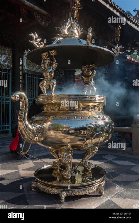 A Big Brass Incense Burner At Longshan Temple In Taipei With Smoke From