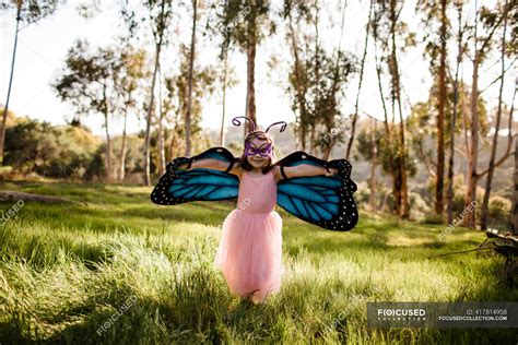 Cute little girl in butterfly costume having fun — wings, family - Stock Photo | #417814958