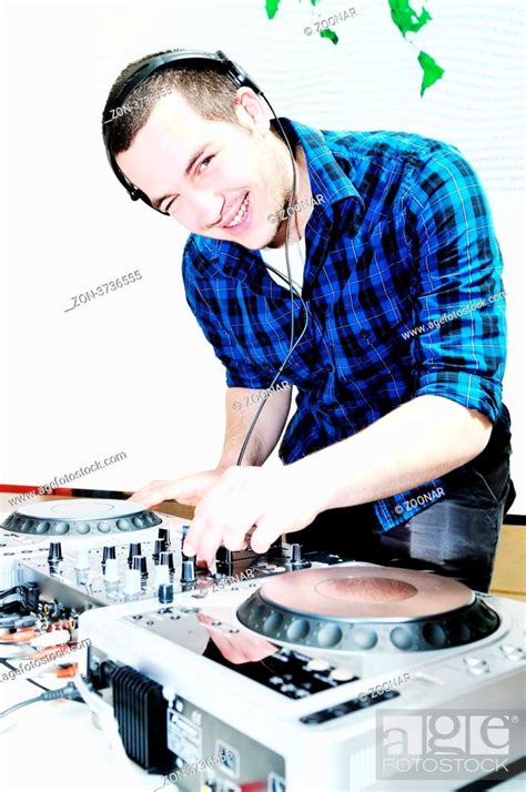 young dj man with headphones and compact disc dj equipment on party ...