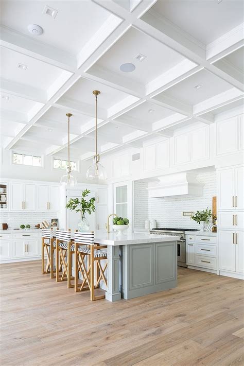 Coastal Farmhouse White Kitchen With Light Grey Island And Boxed Beamed