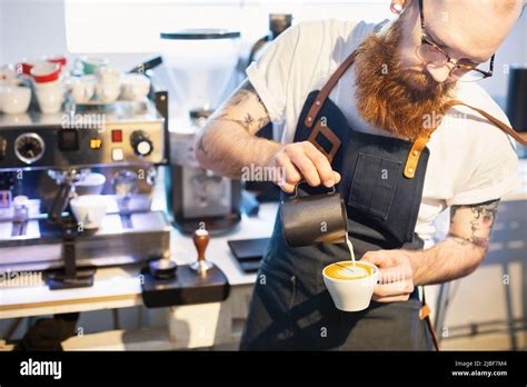 Barista Pouring Milk Into Coffee Stock Photo Alamy