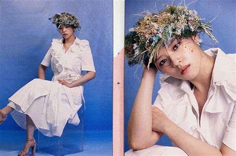 A Woman Sitting On A Chair With Flowers In Her Hair And Wearing A White Dress