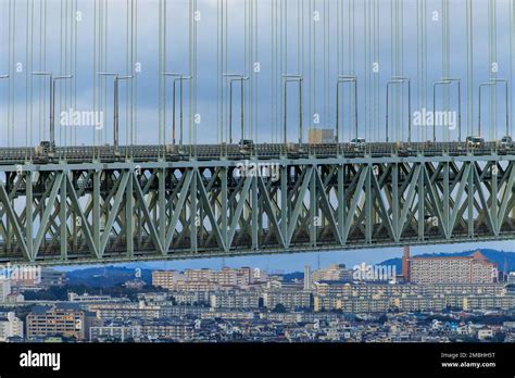 Light Traffic On Bridge Span Over Large Apartment Blocks On Hilly City