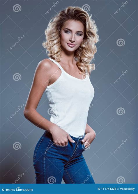 Beautiful Woman Dressed In Blue Jeans And A White T Shirt Stock Photo