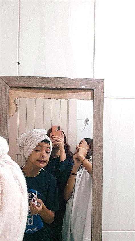 Two Women Are Taking Pictures In The Mirror