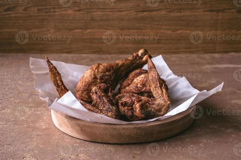 Fried Chicken Legs And Wings In Wooden Dish On The Table