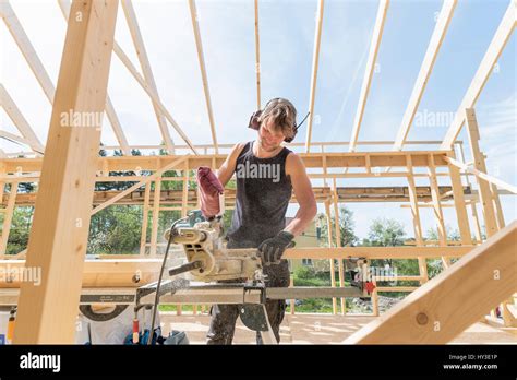 Sweden Sodermanland Carpenter Cutting Wooden Plank With Circular Saw