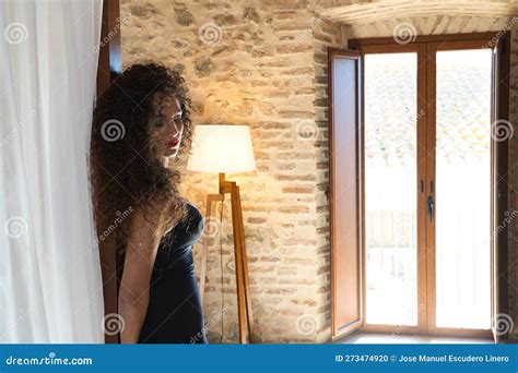 Beautiful Brunette Woman With Curly Hair Leaning On Royal Style Bed