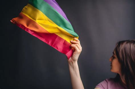 Premium AI Image A Woman Holding A Rainbow Flag In Her Hand