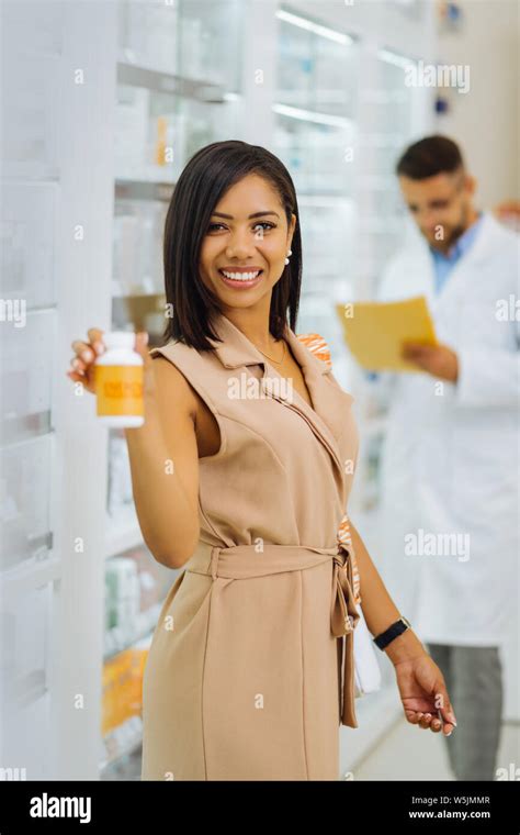 Positive Delighted Brunette Female Showing Her Vitamins Stock Photo Alamy