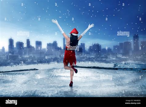 Asian Woman Wearing Santa Claus Costume Standing On The Rooftop