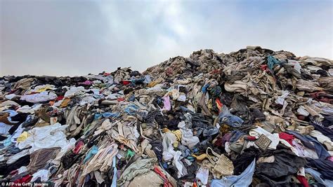 The Fast Fashion Waste Mountain Gigantic Pile Of Clothes Looms Over