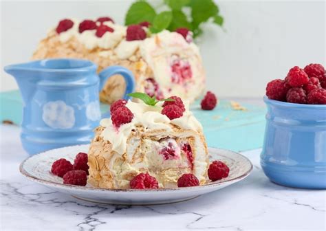 Premium Photo Baked Meringue Roll With Cream And Fresh Red Raspberry