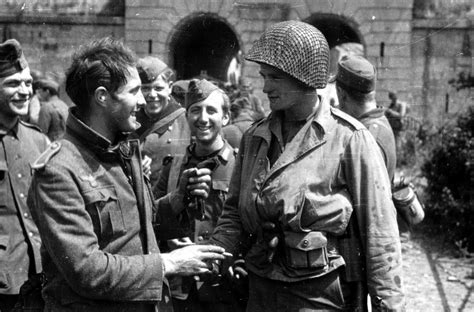 German POWs interact with an American Soldier after the Battle of ...