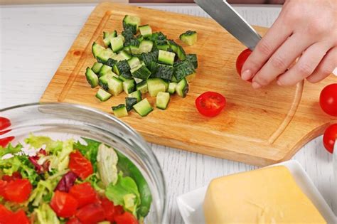 Premium Photo Female Hands Cutting Vegetables For Salad At Kitchen