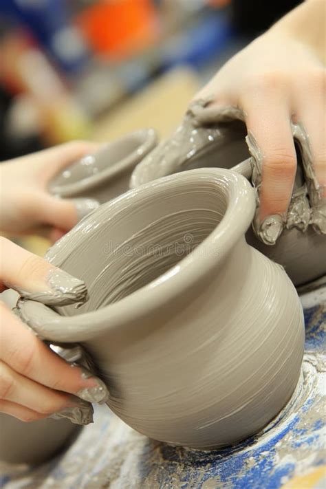 Hands Crafting Clay Pottery On A Spinning Wheel In An Artisan Workshop