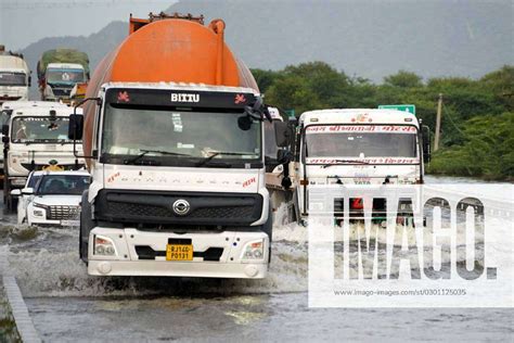 Heavy Monsoon Rainfall India Vehicles Wade Through A Waterlogged Road