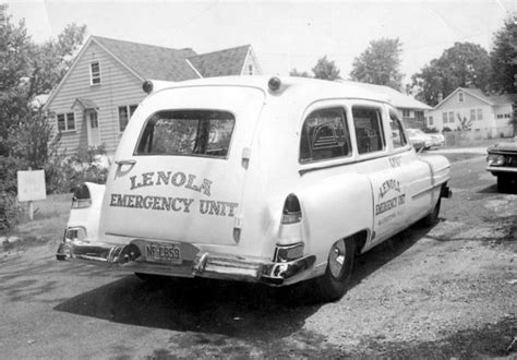 Vintage Ambulance Parked in Front of House