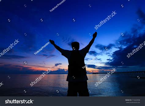 Silhouette Man Hands Raised Beautiful Sunrise Stock Photo 713224558