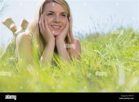 Pretty Blonde In Sundress Lying On Grass Smiling Stock Photo Alamy