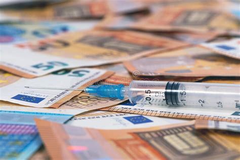 Close Up Syringes And Euros Banknotes Bills Cost Of Health Medicine