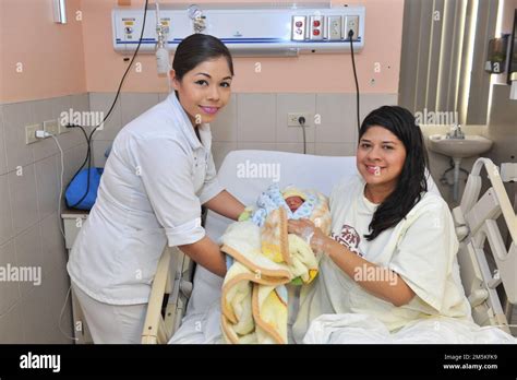 Nurse With Mother And Her Newborn Baby On The Hospital Stretcher