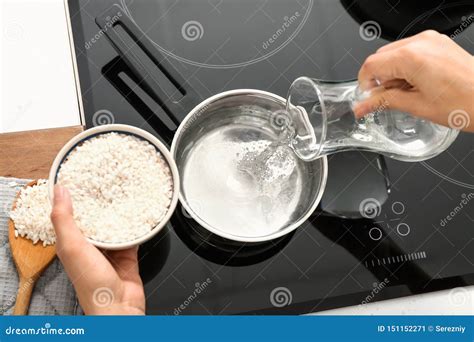 Woman Pouring Water Into Saucepan For Cooking Rice Stock Image Image