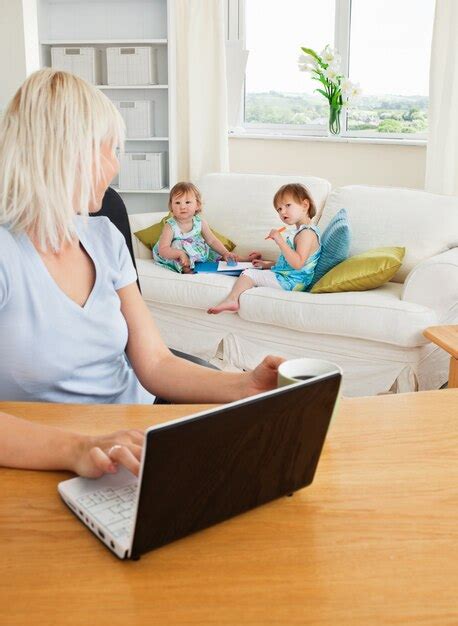 Premium Photo Blond Mother Working At Laptop